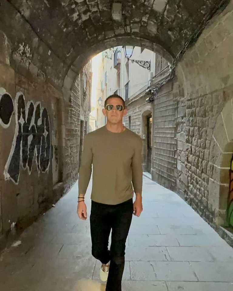 Man walking through a stone archway illustrating weight loss goals and healthy living.