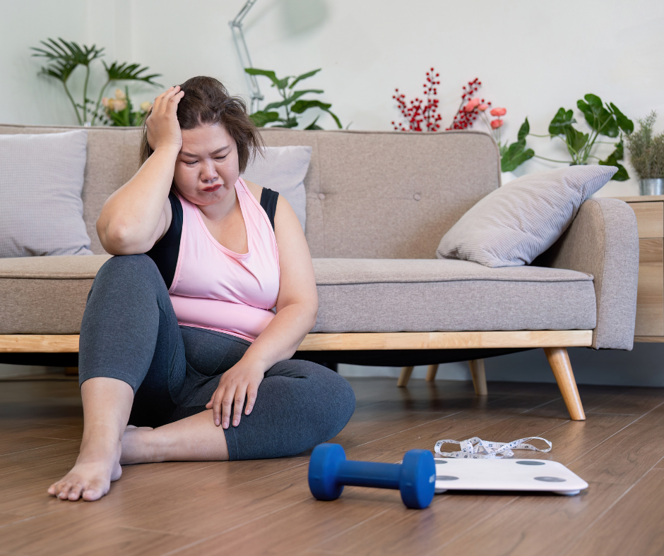 A frustrated woman looking at a scale.