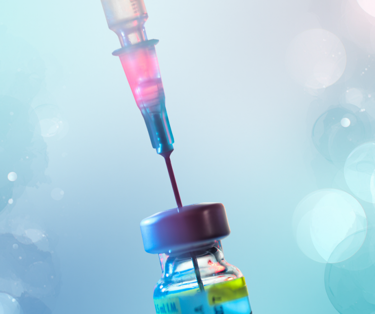 A close up of a syringe and needle poked into a glass medicine vial.